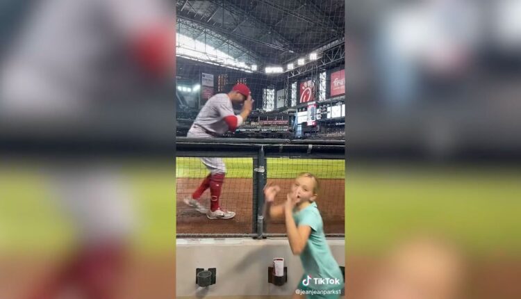 Joey Votto records a TikTok with a young fan